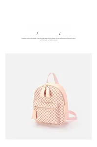 Close-up of mini pink PU leather backpack featuring golden zippers and logo texture