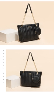 Detail of black V-quilted faux leather tote bag with gold chain strap and mini coin purse