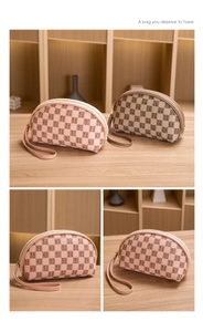 Detail of checkered mini bags with letter patterns, zipper closure and hand strap