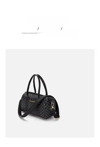 Detail of vintage black barrel bag with geometric dots, golden metal hardware and strap