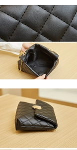 Detail of black quilted leather texture, golden heart buckle and interior of crossbody bag