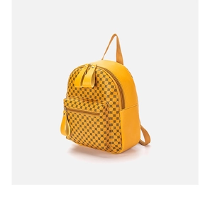 Close-up of yellow backpack with black polka dots featuring front pocket and dual zippers