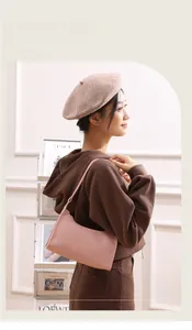 Detailed view of pink quilted shoulder bag featuring fine stitching on a model side profile