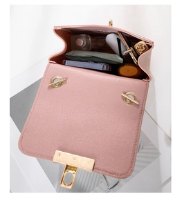 Pink faux leather bag interior showing space for phone, lipstick, and cosmetics