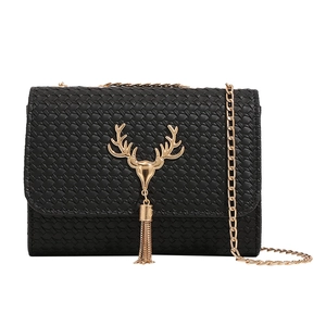 Black woven crossbody bag with gold deer head buckle and elegant fringe detail
