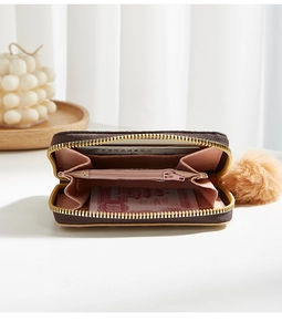 Macro detail of brown checkered wallet featuring pink leather interior and card slots