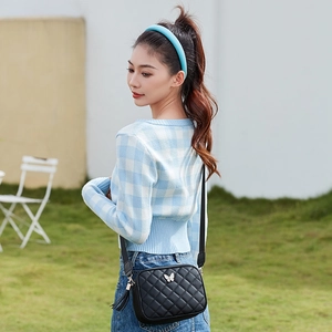 Quilted black crossbody camera bag for women with silver butterfly and tassel details