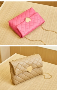 Detail of pink and beige quilted crossbody bags with heart-shaped gold buckles