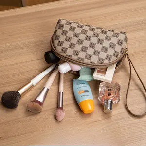 Detailed top view of a khaki checkered makeup bag filled with cosmetics on a wooden table