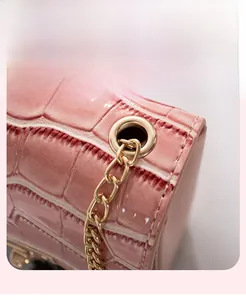 Detailed close-up of pink crocodile texture handbag with premium light gold hardware