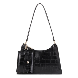 Black crocodile pattern shoulder bag and mini pouch set with gold hardware on white background