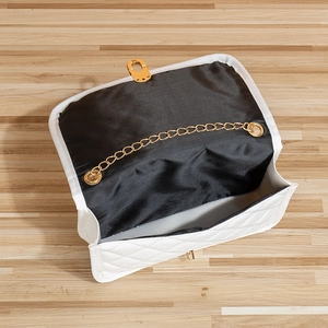 White quilted shoulder bag with gold chain strap and turn-lock closure for women