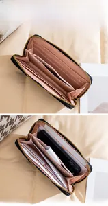 Detailed interior of long black leather wallet showing card slots and phone compartment