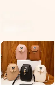 Detailed view of leather crossbody phone bags with rhinestone cat charms in five colors