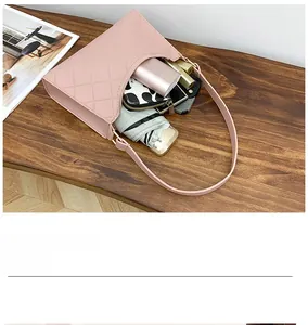Pink quilted shoulder bag showing large capacity for umbrella, wallet and power bank