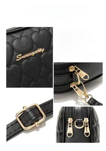 Close-up of heart quilted black leather texture and premium gold hardware on camera bag