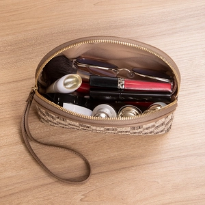 Brown checkered arched makeup bag with wristlet strap and metallic zipper closure