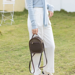 Retro round backpack featuring classic geometric prints and brown leather trim details