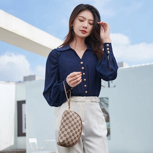 Navy blue V-neck chiffon shirt with gold buttons and white pants outdoor outfit