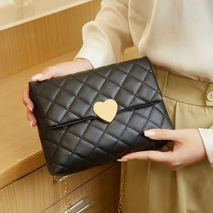 Quilted heart lock handbag in black with elegant gold chain strap for women