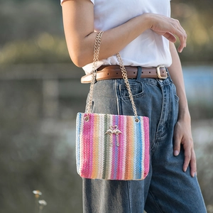 Rainbow striped woven bucket bag with golden flamingo clasp and chain strap