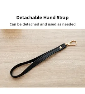 Close-up of a detachable black PU leather wrist strap with gold swivel hook for purses
