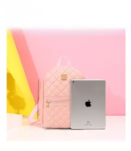 Mini zaino trapuntato rosa con dimensioni 23x26x10cm accanto a un tablet per scala