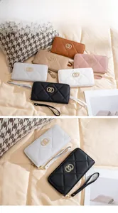 Close-up of quilted long wallets in multiple colors with gold logo and wrist strap
