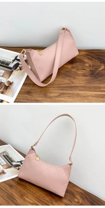 Detail of pink quilted baguette bag with gold zipper and minimalist synthetic leather texture
