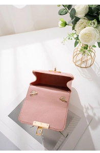 Detailed top view of pink crocodile textured mini shoulder bag with gold metal hardware
