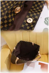 Détail du grand sac cabas avec fermeture magnétique et motif trèfle doré sur marron
