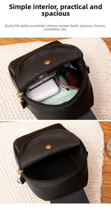 Detail view of the spacious inner compartment of this black mini crossbody phone bag