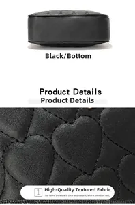 Detail view of the black heart-quilted leather texture and bottom base of the camera bag