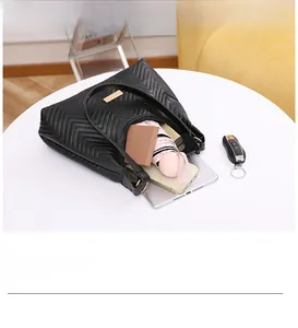 Interior view of black quilted tote bag showing ample space for tablet and umbrella