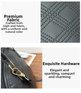 Detail of black Boston handbag featuring geometric embossed texture and gold metal hardware