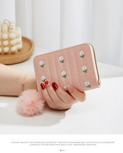 Pink PU leather short wallet featuring floral embroidery and a plush ball zipper charm