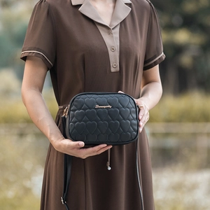 Black heart quilted PU leather camera bag with gold logo and adjustable strap