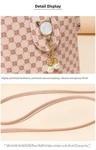 Detail of high-polish hardware with pearl pendant and clover print on crossbody bag