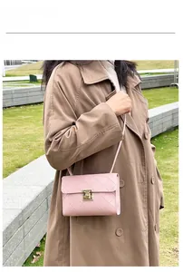 Outdoor model shot of a pink quilted crossbody bag featuring a golden twist lock buckle