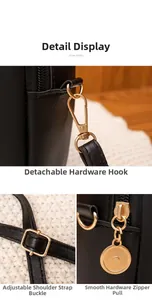Detail of black leather phone bag showing golden hardware and detachable strap hooks