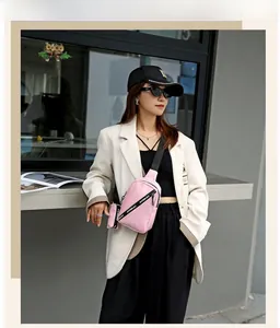 Pale pink crossbody chest bag with adjustable logo strap and small detachable round pouch