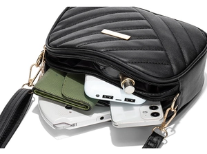 Detail view of black quilted shoulder bag interior showing spacious storage capacity