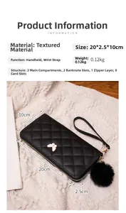 Detail of black quilted wallet with butterfly ornament and pompom, size 20x2.5x10cm