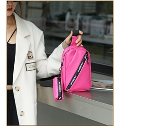 Hot pink mini crossbody bag with a matching small charm pouch and FIRIGHT strap details