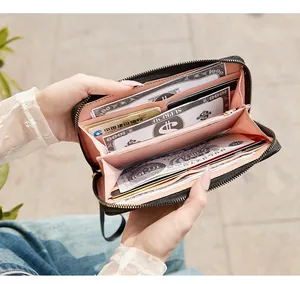 Detailed view of the black quilted long wallet interior with pink compartments and card slots