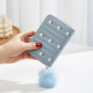 Mini light blue embroidered flower coin purse with a soft blue pompom keychain charm