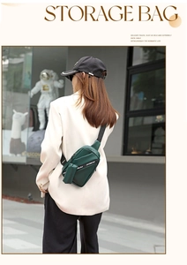Outdoor street view of a dark green crossbody chest bag with adjustable nylon straps