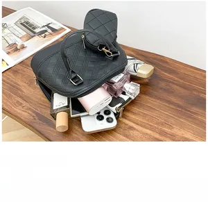 Internal view of the quilted shell bag showing space for phone, umbrella, and essentials