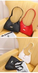 Detail view of wave quilted and woven textures on stylish underarm bags with gold hardware