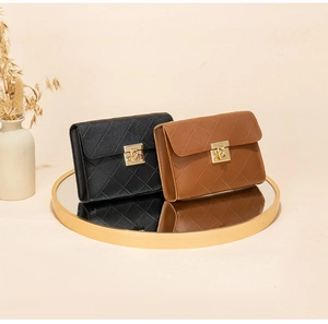 Detail of rhombic quilted crossbody bags with golden rectangular twist lock and accordion sides